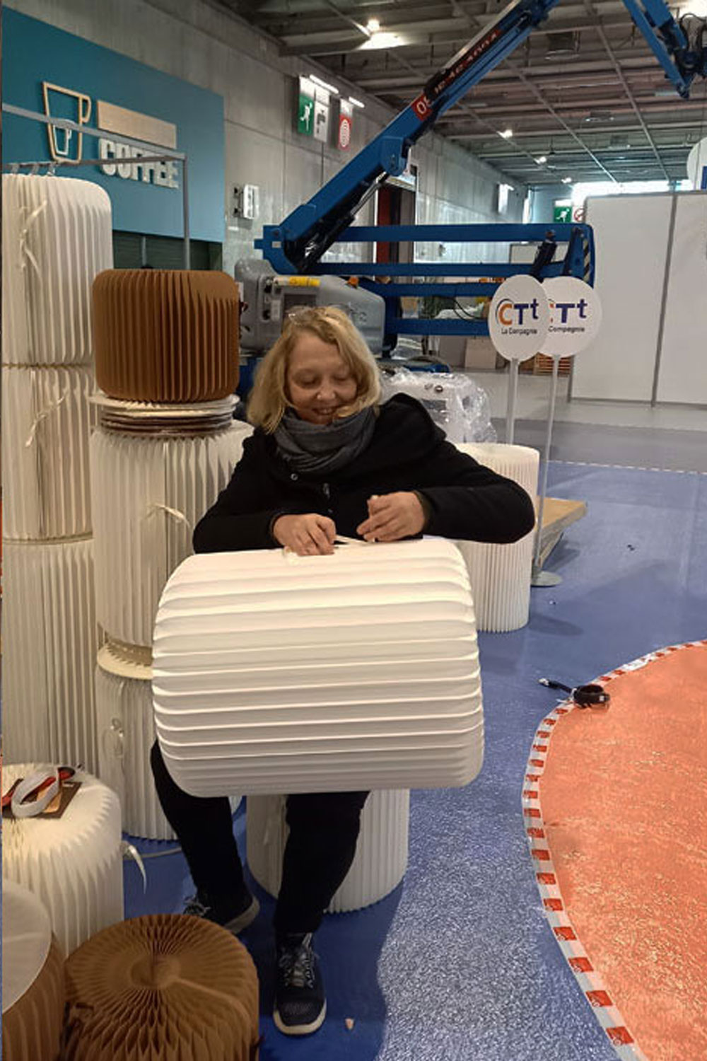 Designdelo-conception-agencement-conseil-professionnels-stand-salon-2 Laurence installant les poufs stooly pour le Stand CTT